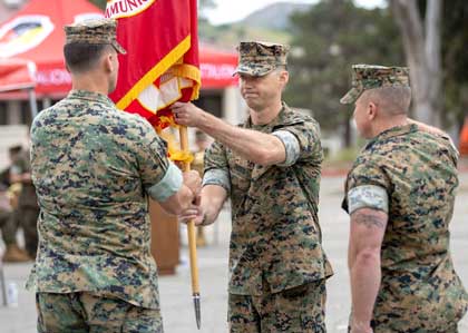 U.S. Marine Corps Lt. Col. Jefferey M. Rohman, left, the outgoing commanding officer of 9th Communication Battalion, I Marine Expeditionary Force Information Group, passes the organizational colors to Lt. Col. Robert A. Doss III, the oncoming commanding officer, during the 9th Communication Battalion change of command ceremony at Marine Corps Base Camp Pendleton, California, June 8, 2023. The passing of colors from an outgoing commander to an incoming commander ensures that the unit and its Marines are never without official leadership, represents a continuation of trust, and signifies an allegiance of Marines to their unit's commander. U.S. Marine Corps photo by Lance Cpl. Trent A. Henry