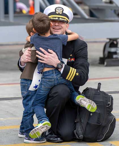 SAN DIEGO (Oct. 15, 2024) U.S. Navy Cmdr. Matthew Den Herder greets family members following the return of the Nimitz-class aircraft carrier USS Theodore Roosevelt (CVN 71) to San Diego after a scheduled nine-month deployment, Oct. 15, 2024. Theodore Roosevelt, the flagship of the Theodore Roosevelt Carrier Strike Group, returned to its homeport after conducting operations in the U.S. 3rd, 5th, and 7th Fleet areas of operation as part of a routine deployment in support of global maritime security operations. As an integral part of U.S. Pacific Fleet, Commander, U.S. 3rd Fleet operates naval forces in the Indo-Pacific and provides the realistic and relevant training necessary to execute the U.S. Navy’s timeless role across the full spectrum of military operations-from combat missions to humanitarian assistance and disaster relief. U.S. 3rd Fleet works in close coordination with other numbered fleets to provide commanders with capable, ready forces to deploy forward and win in day-to-day competition, in crisis, and in conflict. U.S. Navy photo by MCSN Aaron Haro Gonzalez