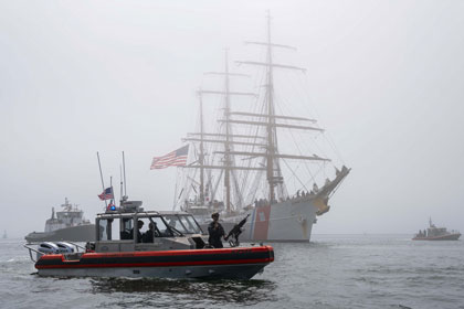 EAGLE ARRIVAL: A patrol vessel helps escort the Coast Guard cutter Eagle in the Port of Los Angeles as it arrives for Fleet Week, May 21. Los Angeles Fleet Week, now in its eighth year, allows the public to learn about the maritime capabilities of Sailors, Marines and Coast Guardsmen. US Navy photo by Seaman Angel Campbell.