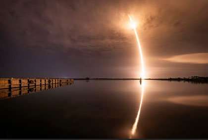 Radiant Reflection: A Falcon 9 rocket launches for a mission from Space Launch Complex 40 at Cape Canaveral Space Force Station, Fla., July 2, 2025. The mission added another 27 satellites to the constellation of more than 7,000 satellites currently in low Earth orbit. Photo by Robert Mason, Space Force