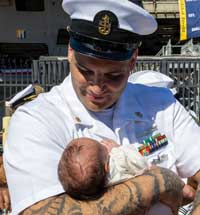 U.S. Navy Sailors reunite with family members and their children as the Nimitz-class aircraft carrier USS Abraham Lincoln (CVN 72), returns from a deployment at Naval Station North Island, Calif., Oct. 8, 2026.